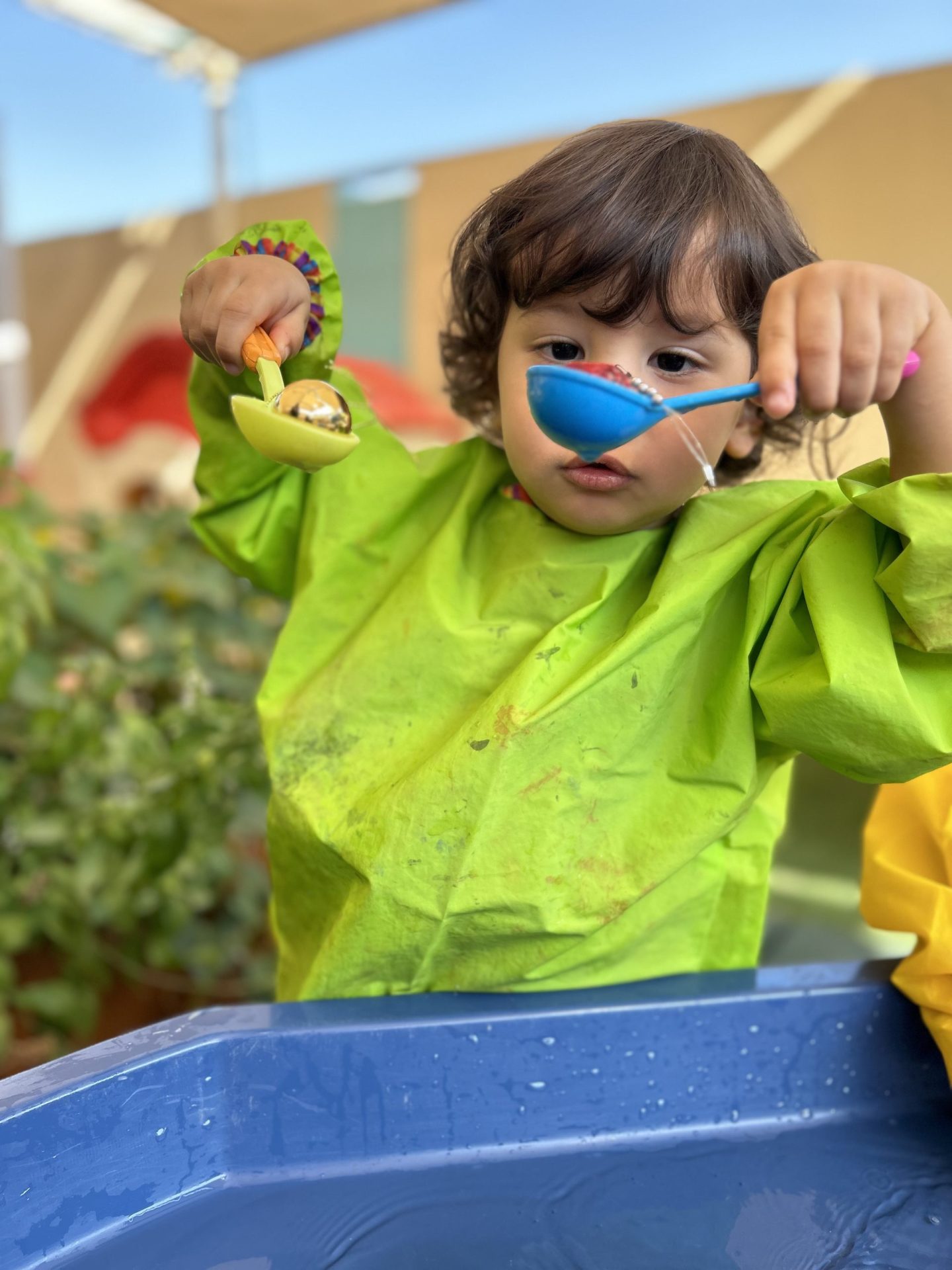 Kids playing in the water to enhance fine motor skills at Nursery in Al Awir